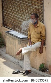 Chennai,Tamil Nadu/India - 10/16/2020: An Indian Rickshaw Driver Wearing A Mask For Covid-19, Takes A Puff At A Cigarette  