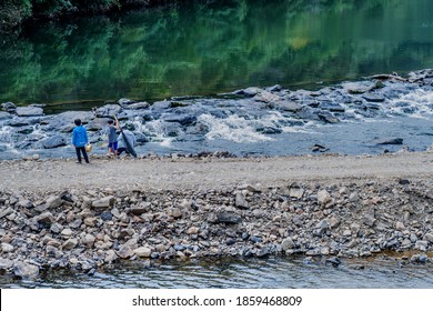 Cheongyang-gun, South Korea; October 2, 2020: For Editorial Use Only. Unidentified Father And Sons Fishing In River Beside Gravel Road.