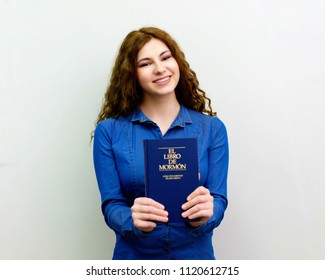 Cherkassy, Ukraine - 29 April 2018. Happy Girl Is Holding Spanish Book Of Mormon And Was Called On A Mission From Church Of Jesus Christ Of Latter-day Saints In Spain.