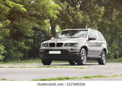 Chernigov, Ukraine - June 16, 2018: BMW X5 on the road in a beautiful forest