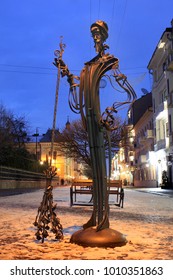 Chernivtsi, Ukraine - December 21, 2017: Sculpture Of A Janitor With Broom On Pedestrian Street Of Olga Kobylianska In Central Chernivtsi, Ukraine At Night.