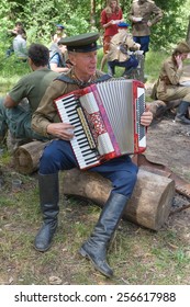 CHERNOGOLOVKA, MOSCOW REGION, RUSSIA - JUNE 21, 2013: Accordionist Playing The Accordion At The Bus Stop To Rest In The Forest, 3rd International Meeting 