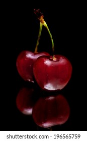 Cherries Isolated On Black Mirror