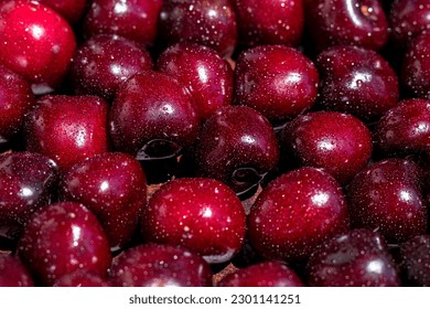 Cherry Background. Selective focus. Ripe sweet cherry berries. In drops of water. Close-up.