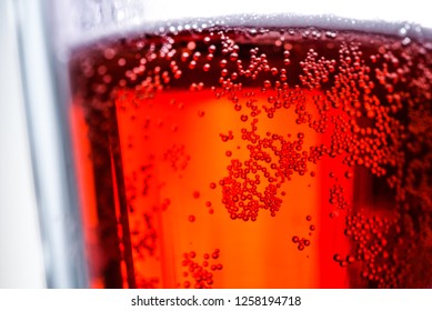 Cherry beer with bubbles in a glass beaker. Photo for design, advertising, banners, beer festival, October fest, posters, prints, shop. Glass mug of tasty fruit beer macro. Liquid texture closely.