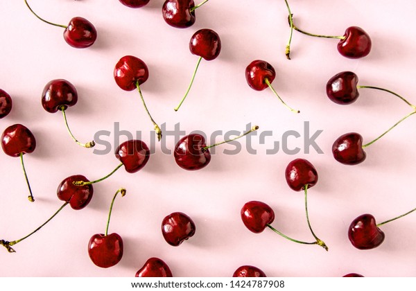 \
Cherry berries on a\
pink background top view. Background with cherry on sprigs. Cherry\
berries on a pink background top view. Background with a cherry on\
a sprig,  flat lay