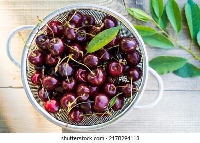 Cherry Berries On A Wooden Table In A Colander, Summer Food, Top View