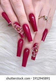 Cherry Blossom Flowers On Artificial Nails, Young Lady Hands With Manicured Nail Art Design, Dark Red Cherry Color Nails