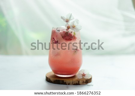 The cherry blossom pink ice beverage on the table.