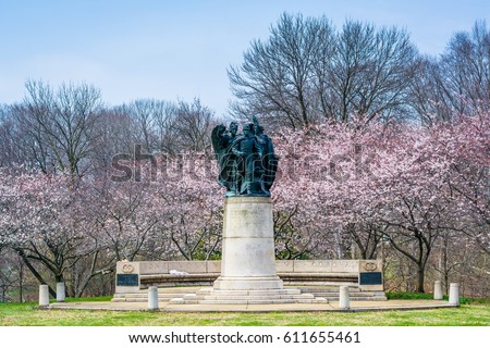 Cherry blossoms and statue at Wyman Park, in Charles Village, Baltimore, Maryland.