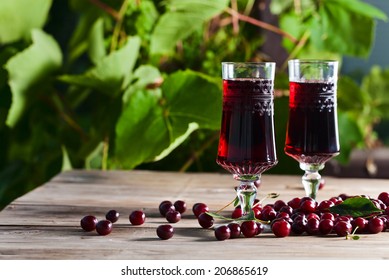 Cherry Brandy And Ripe Berries On  Wooden Table