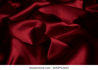 Cherry cardinal red, ruby blood, wine, love, marron, scarlet, carmine trendy passionate bright intense elegant color. Silk satin wrinkled crumpled texture background with folds. Underwear sleek fabric