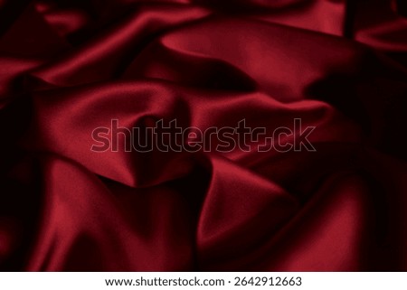 Cherry cardinal red, ruby blood, wine, love, marron, scarlet, carmine trendy passionate bright intense elegant color. Silk satin wrinkled crumpled texture background with folds. Underwear sleek fabric