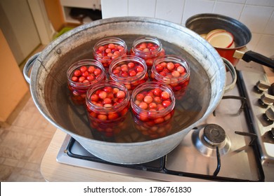 Cherry Compote Being Prepared For Winter Preservation In A Big Pot On A Stove, Where All Bacteria Is Destroyed Because Of Heat.