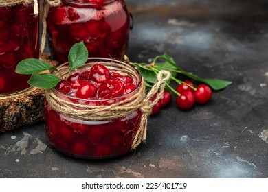 Cherry confitur jam in a jar and fresh berries on the table. Preserved organic food from garden on a dark background. banner, menu, recipe place for text. - Shutterstock ID 2254401719