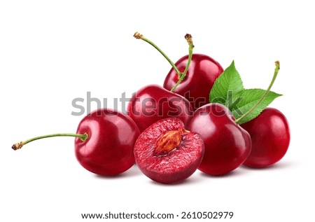Cherry with cut in half isolated on white background.