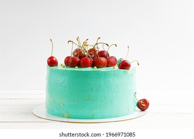 Cherry Decorated Homemade Cake On White Wooden Table. Front View.