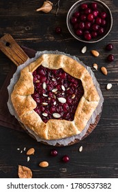 Cherry Galette with almonds on wooden, top view, copy space. Homemade organic healthy dessert - cherry pie or french galette.