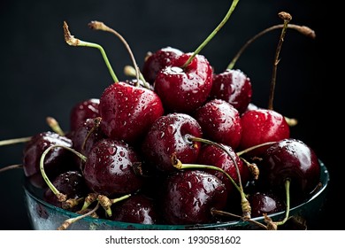 Cherry in the glass bowl on black background - Powered by Shutterstock