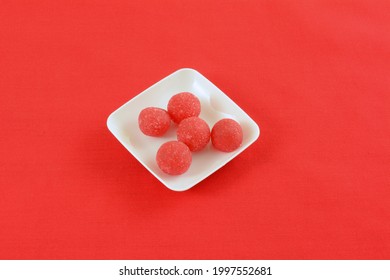 Cherry Hard Candy Balls With Gummy Center In White Candy Dish On Red Background