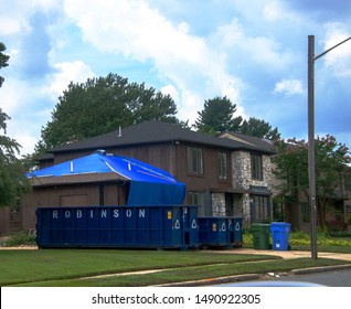 Cherry Hill, New Jersey - August 18, 2019: Large Brown Wooden House Is Seen With Blue Tarp Over Garage Roof And Two Dumpsters In The Driveway Due To Renovation After Storm Damage