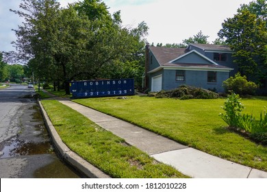 Cherry Hill, New Jersey - August, 2020: A Long Blue Dumpster Is Seen In A Driveway In Front Of A House