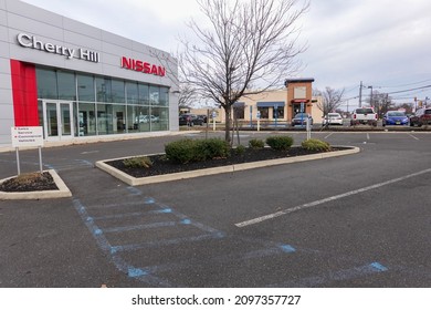 Cherry Hill, New Jersey - December, 2021: A Nissan Car Dealership With Its Parking Lot Almost Empty Due To A Supply Chain Disruptions Of Materials Used To Manufacture New Cars