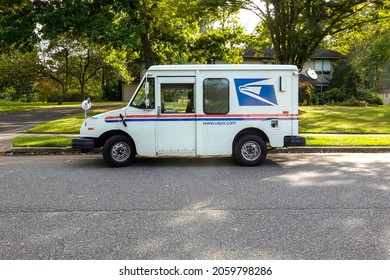 Cherry Hill, New Jersey, October, 2021: A US Postal Service Delivery Van Is Seen Parked On A Street In Front Of A Neighborhood House