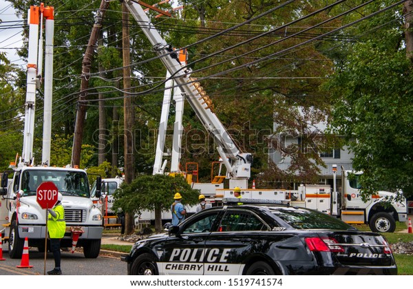 Cherry Hill, New Jersey - September 30, 2019:\
Utility crews were repairing fallen electric wires and poles after\
a strong storm caused extensive damage in this township. Police\
closed many roads.