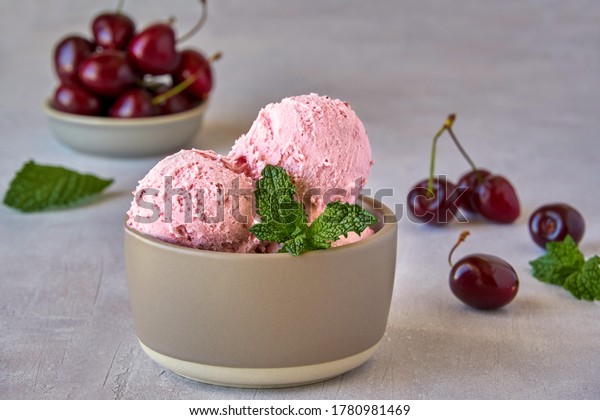 Cherry ice\
cream in bowl  with fresh cherry .\
Closeup