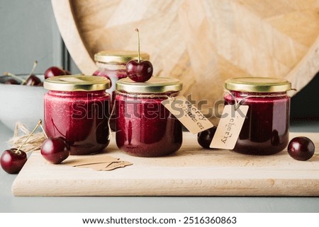 Cherry jam in small jars on the table. Home canning.