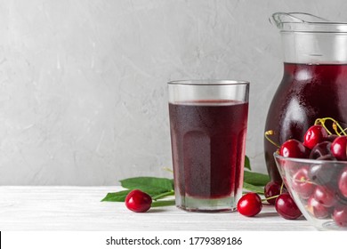 Cherry Juice In A Glass And Jug With Fresh Berries On White Background. Refreshment Summer Drink. Healthy Drink