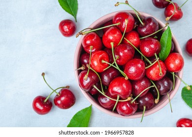 Cherry with leaf on plate and water dropsand on grey stone table. Ripe ripe cherries. Sweet red cherries. Top view. Rustic style. Fruit Background