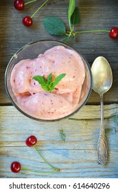 Cherry Mousse In A Glass Bowl On A Wooden Background.