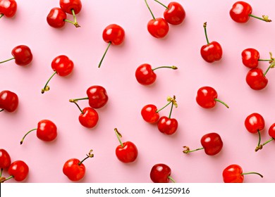 Cherry pattern. Flat lay of cherries on a pink background.Top view