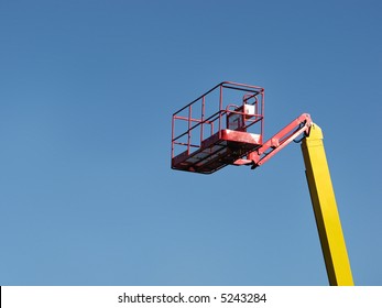 Cherry Picker Isolated On Blue Sky.