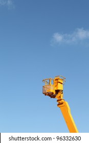 Cherry Picker Platform Against A Blue Sky