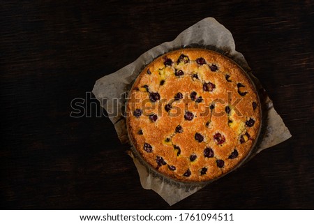 Cherry pie on a dark background. View from above. Free space for an inscription.