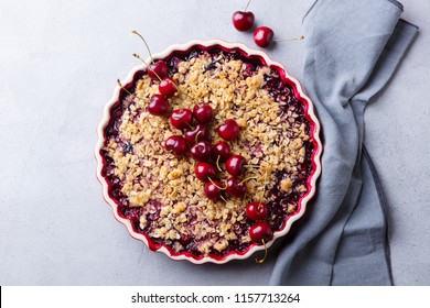 Cherry, Red Berry Crumble In Baking Dish. Grey Stone Background. Top View.