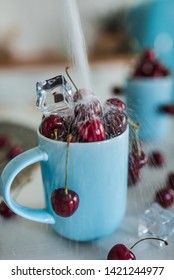 Cherry sprinkling with sugar in the blue cups served on kitchen 