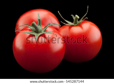 Cherry tomato bunch closeup isolated on black background