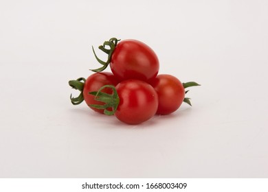 The cherry tomato is a type of small round tomato believed to be an intermediate genetic admixture between wild currant-type tomatoes and domesticated garden tomatoes. with white background.