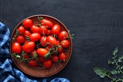 Cherry Tomatoes In A Clay Bowl On A Dark Surface, Top View. Copy Space.