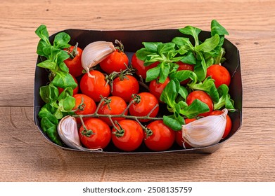 Cherry Tomatoes with Garlic and Lamb's Lettuce in Cardboard Box - Powered by Shutterstock