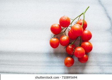 Cherry tomatoes on marble background, close up, selective focus