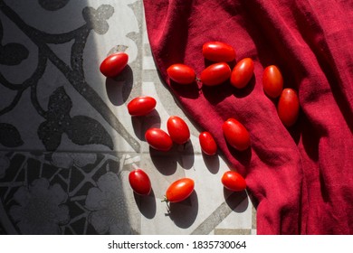 Cherry tomatoes on red kitchen towel. Top view photo with copy space. 