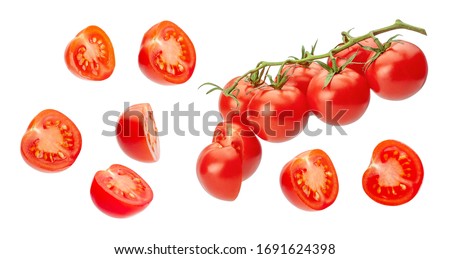 Cherry tomatoes. Pieces of tomatoes are cut in half and whole vegetables on a branch. Isolated on a white background.