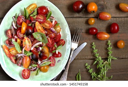  cherry tomatoes salad of different colors and basil. bright summer salad. 