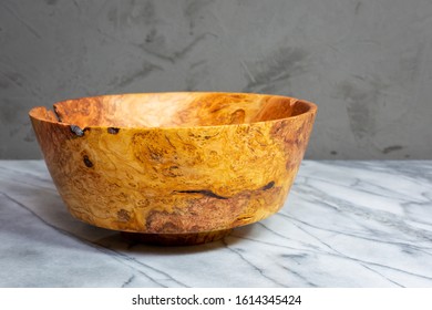 Cherry Wood Bowl With Figured Grain Next To A Burl