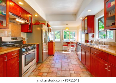 Cherry Wood Kitchen With Tile Floor And Sunny Table Home Interior.